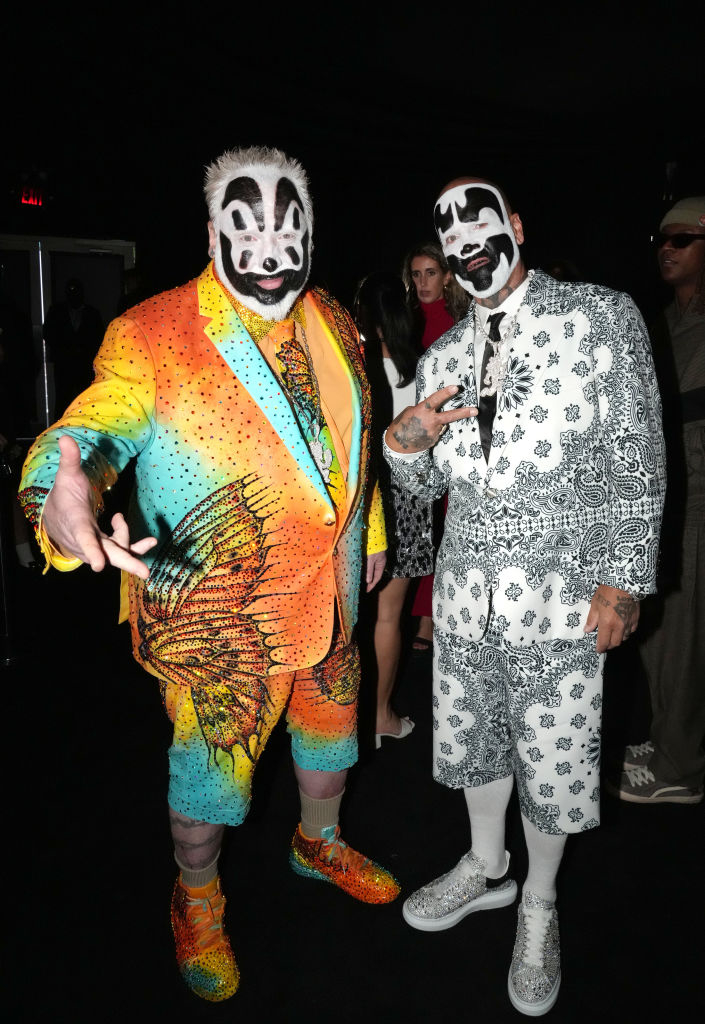 Violent J and Shaggy 2 Dope from Insane Clown Posse in colorful clown-themed suits, posing and making hand gestures at an event