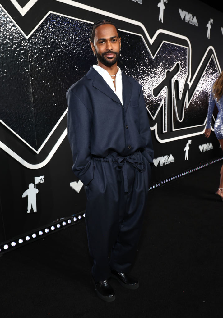 Big Sean at the MTV VMAs wearing an oversized dark suit, standing on the red carpet