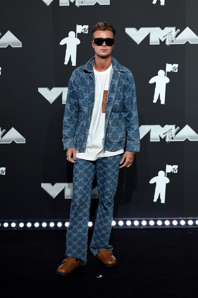 Jaden Bojsen on the red carpet in a denim jacket and matching pants, a shirt, sunglasses, and leather shoes at the VMAs