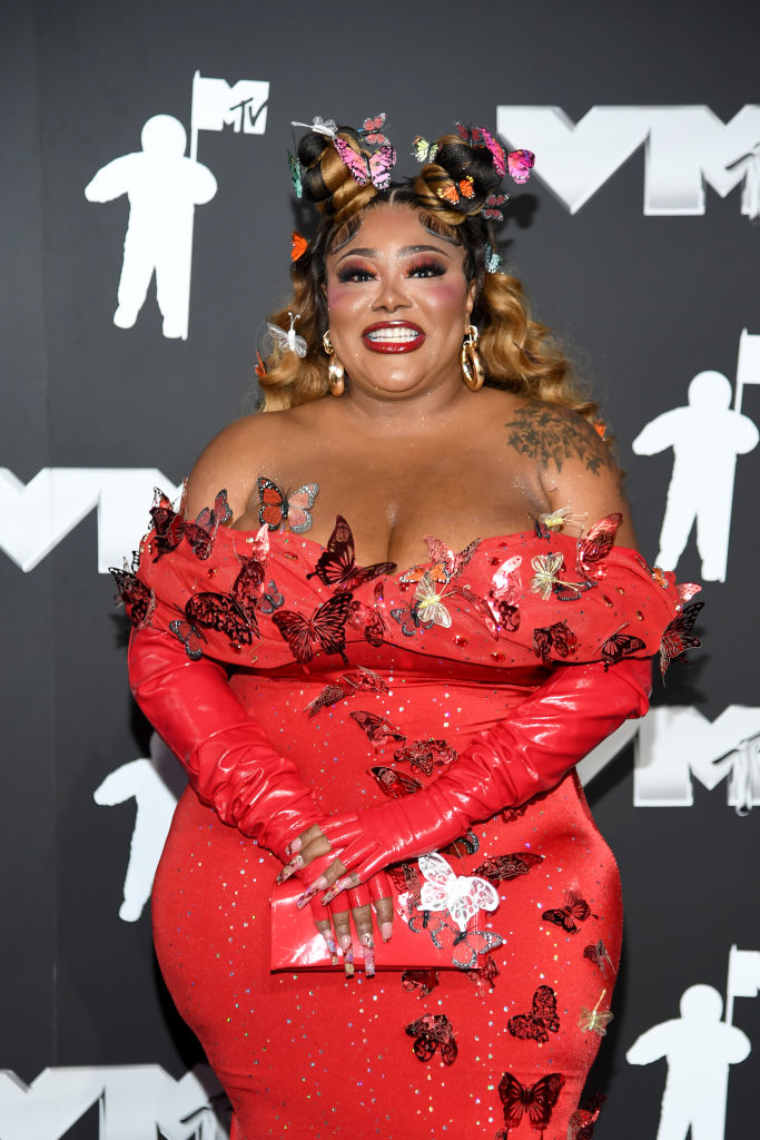 Ts Madison in gown adorned with butterfly embellishments and matching gloves, with butterfly accessories in hair