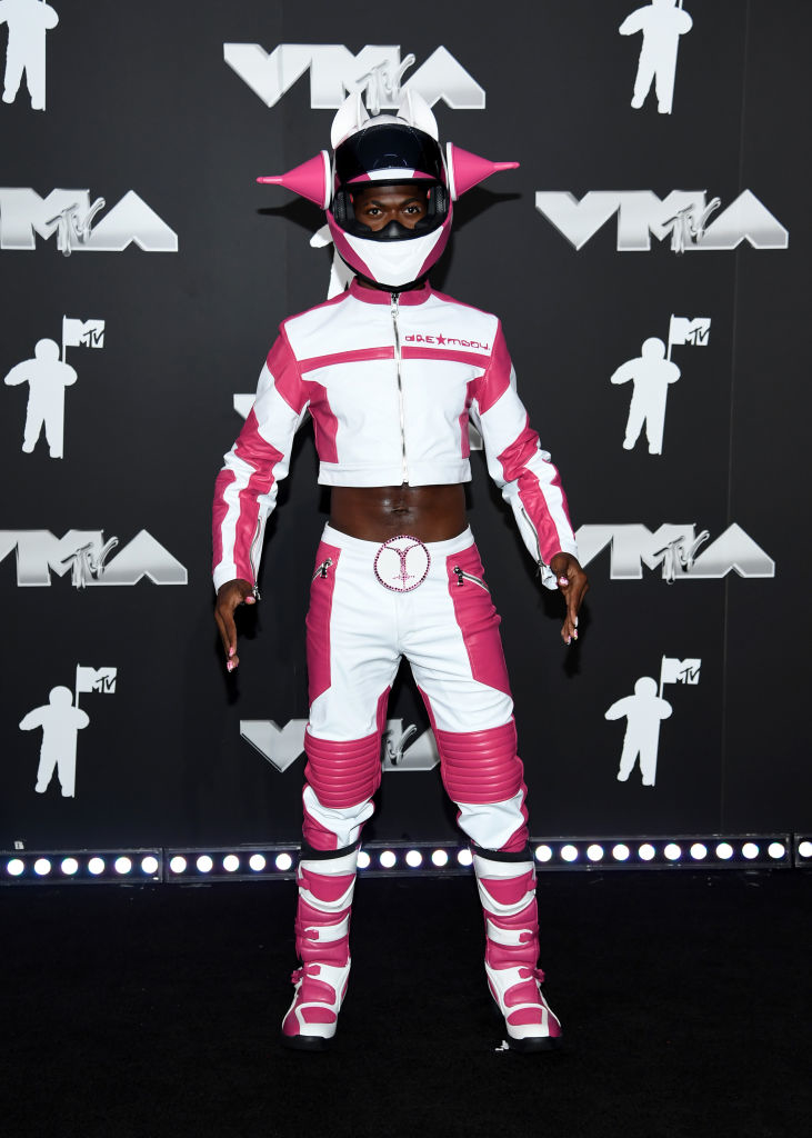Lil Nas X at the MTV VMAs in futuristic motorcycle-themed attire with helmet with antennae