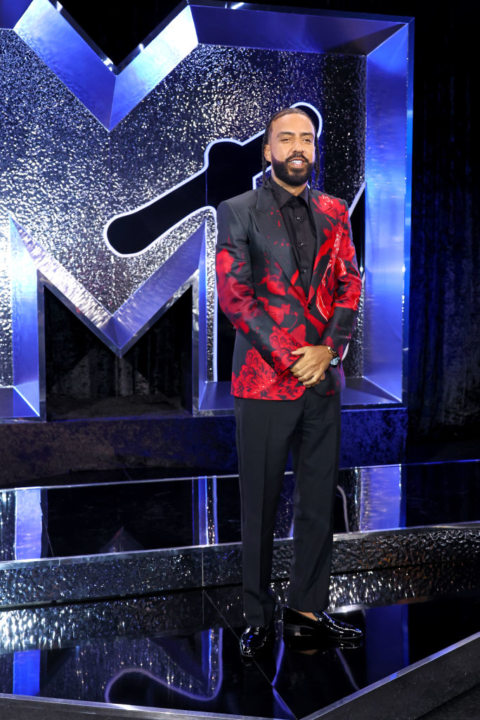 French Montana in a floral suit standing in front of an MTV backdrop