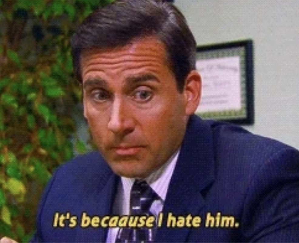 Steve Carell, dressed in a business suit, looking puzzled with the caption "It's because I hate him." in the scene from "The Office"