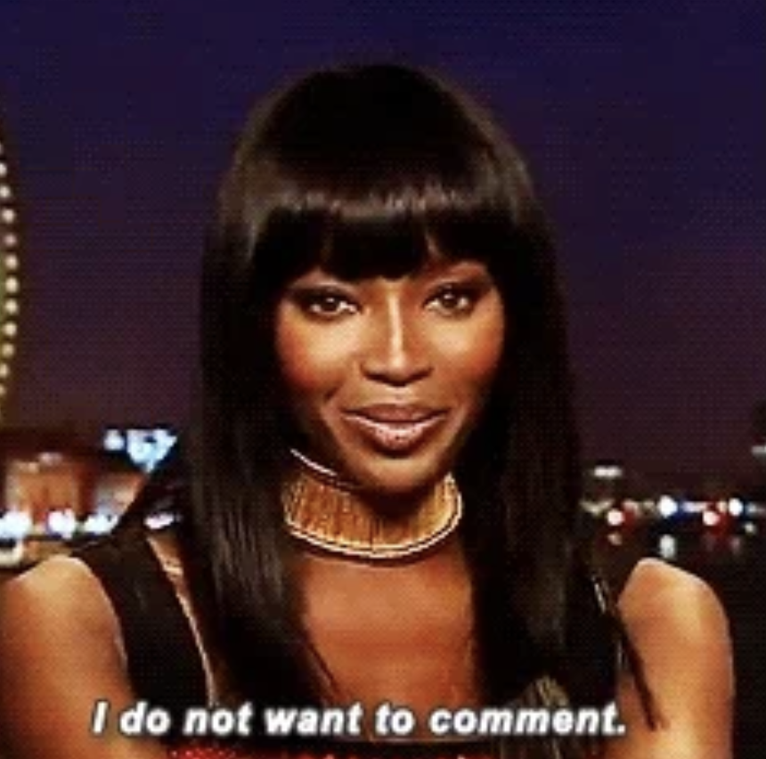 Naomi Campbell, wearing a gold statement necklace, looks at the camera with a small smile. Text overlay: "I do not want to comment."