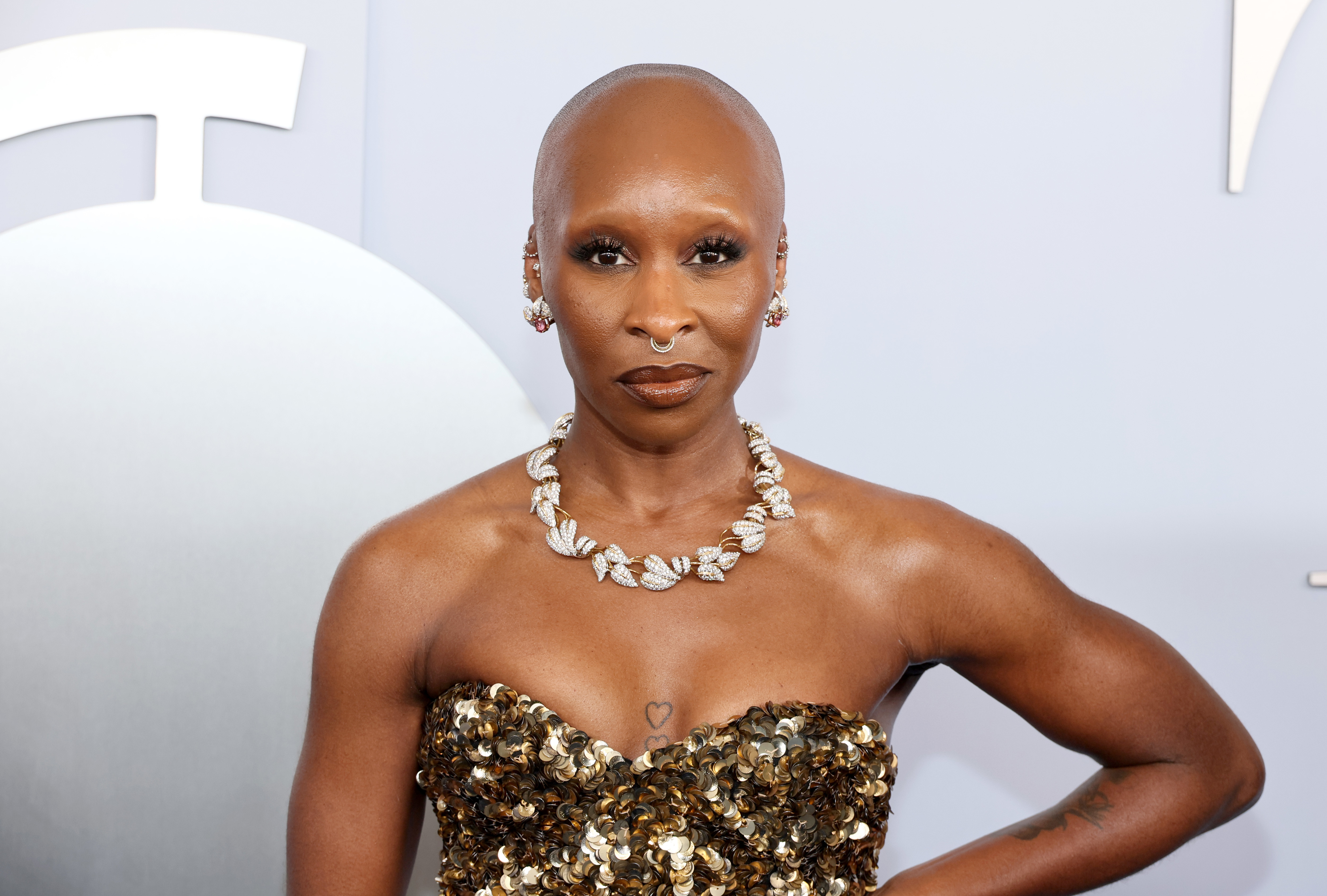 Cynthia Erivo on the red carpet wearing a strapless, sequined gown and a statement necklace