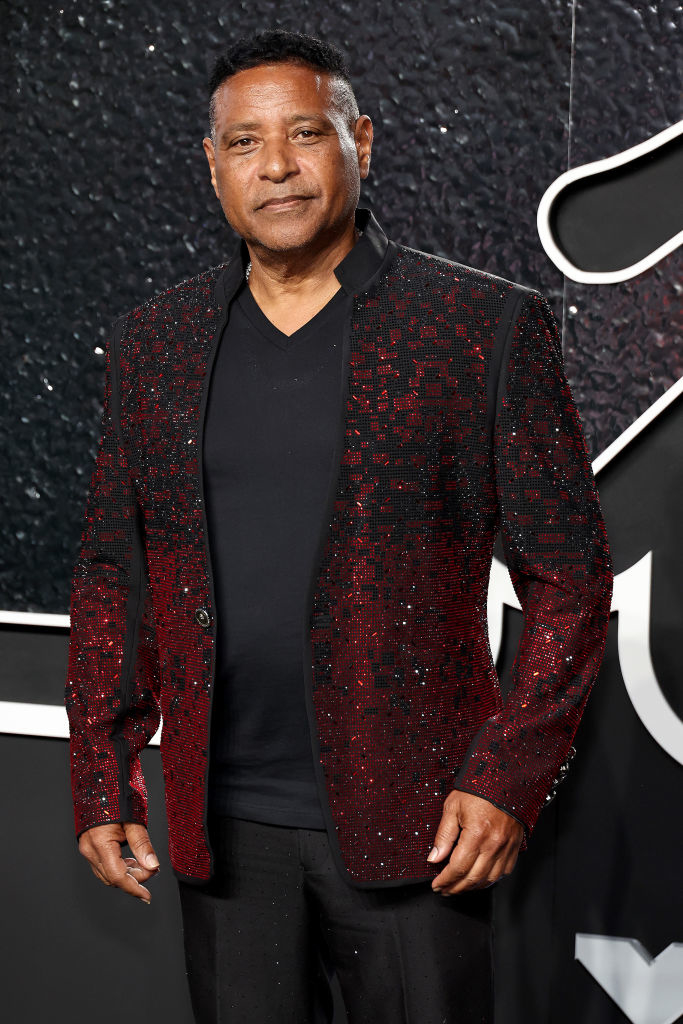 Stevie B on the red carpet wears a glittering, tailored jacket over a dark shirt