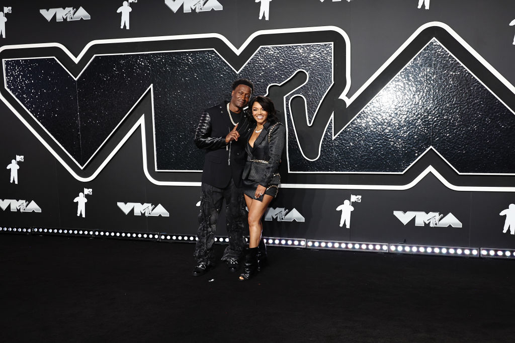 Kirk Frost and Rasheeda, wearing coordinated dark outfits
