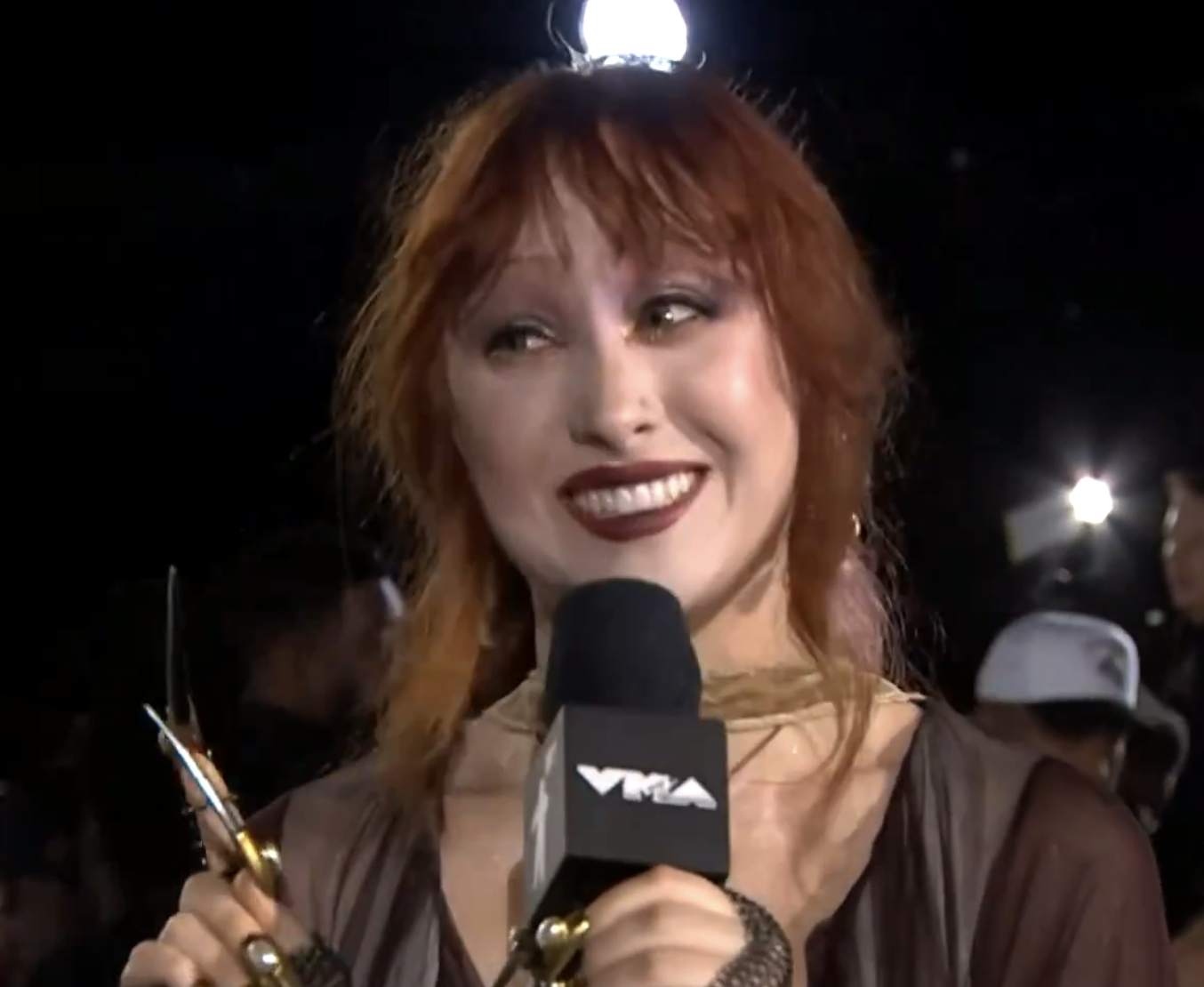 Chappell smiling and holding mic