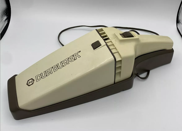 Black &amp;amp; Decker DustBuster handheld vacuum cleaner with cord, showcasing classic retro design