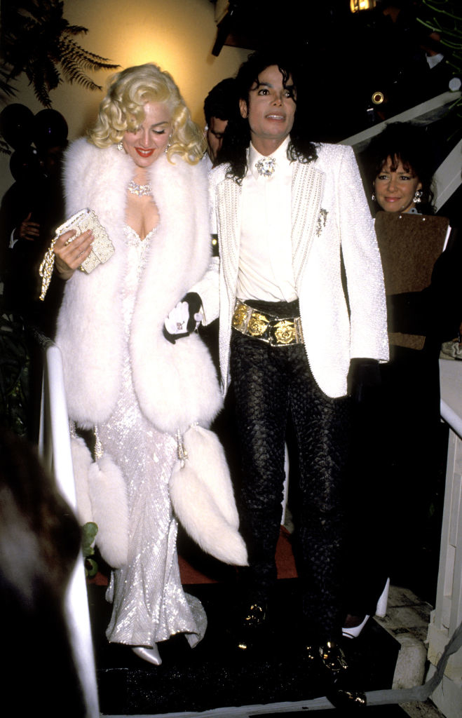 Madonna in a glamorous fur coat and sequined gown, and Michael Jackson in a jacket with pants and gold belt at a formal event