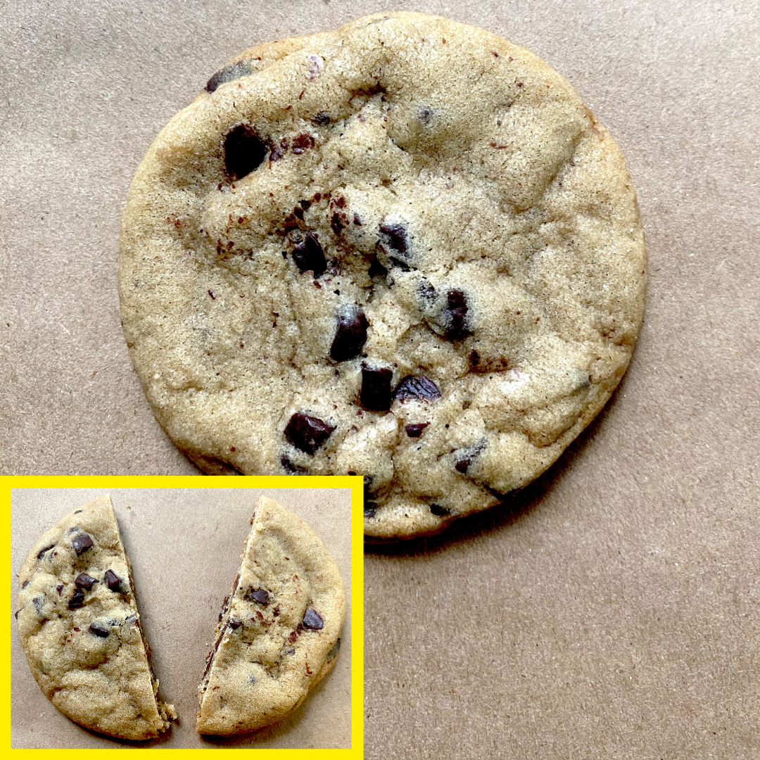 Chocolate chip cookie on a brown surface with a cut-in-half cookie in a yellow-bordered inset