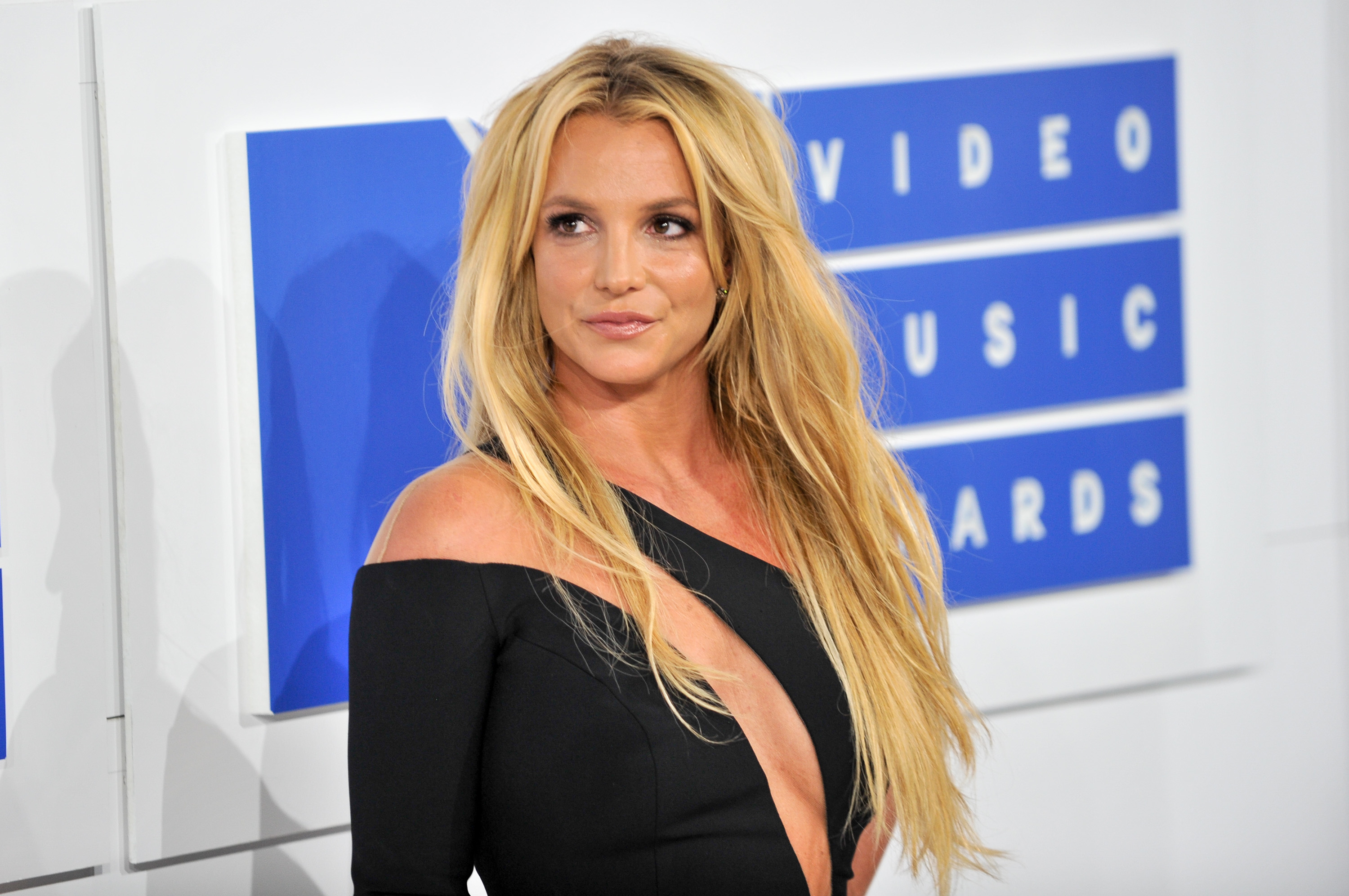 Britney Spears at the Video Music Awards, wearing an off-the-shoulder dress with a deep neckline