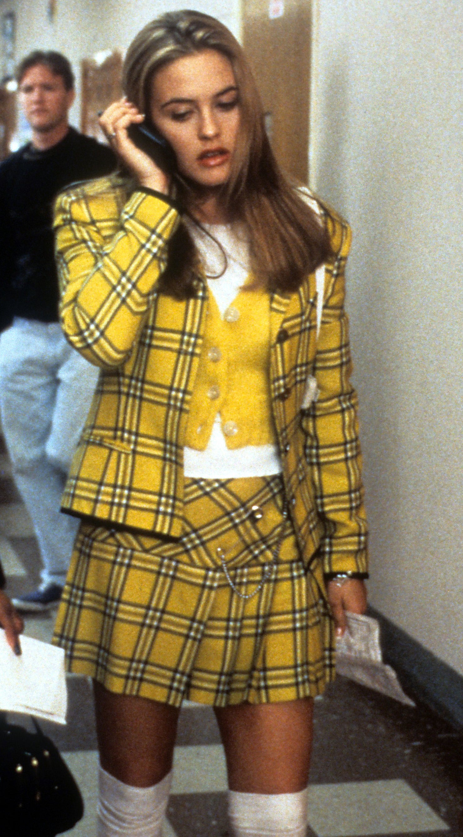 Alicia Silverstone in "Clueless" wearing plaid skirt and blazer, talking on cellphone