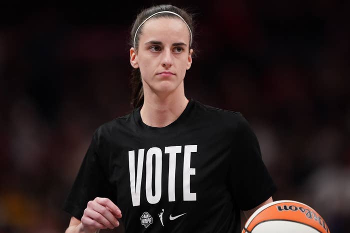 Sabrina Ionescu holding a basketball and wearing a black shirt with the word "VOTE" in large white letters