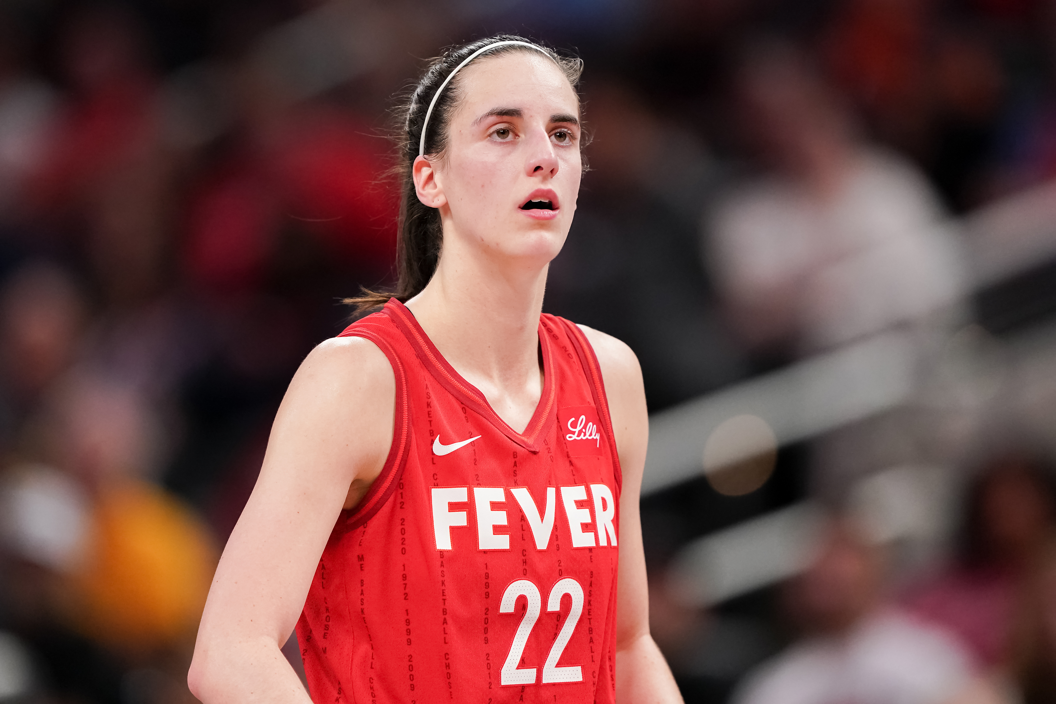 Kelsey Mitchell wearing a sleeveless jersey with "FEVER" and the number 22 during a game