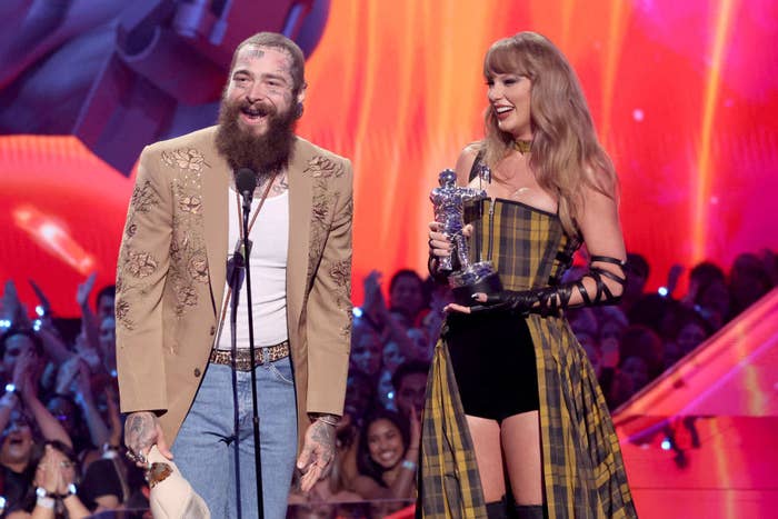Post Malone and Taylor Swift on stage, Post Malone in a floral jacket and jeans, Taylor Swift holding an award in a plaid dress