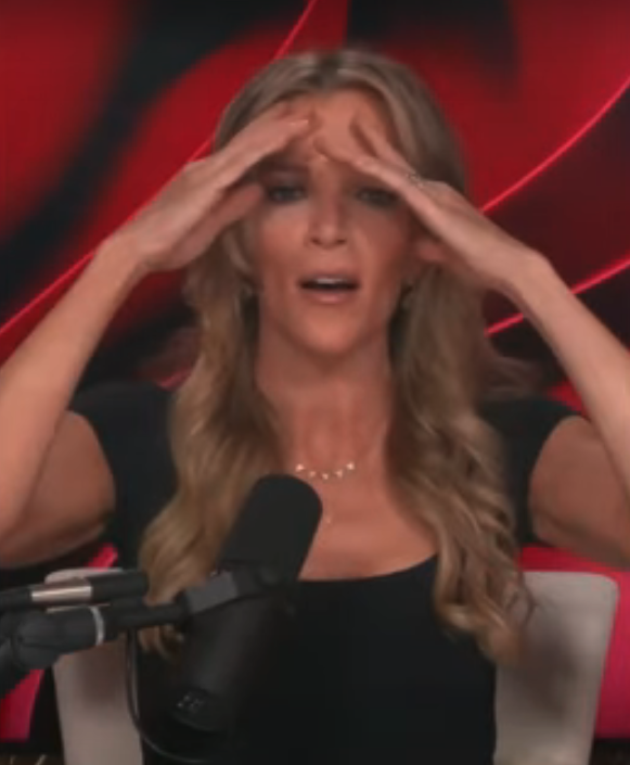 Megyn Kelly is seated at a microphone with her hands on her forehead, appearing to be in mid-conversation or reaction during a recording
