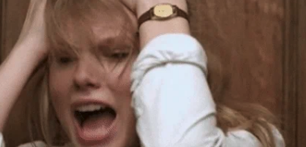 A person holding their head and screaming in distress
