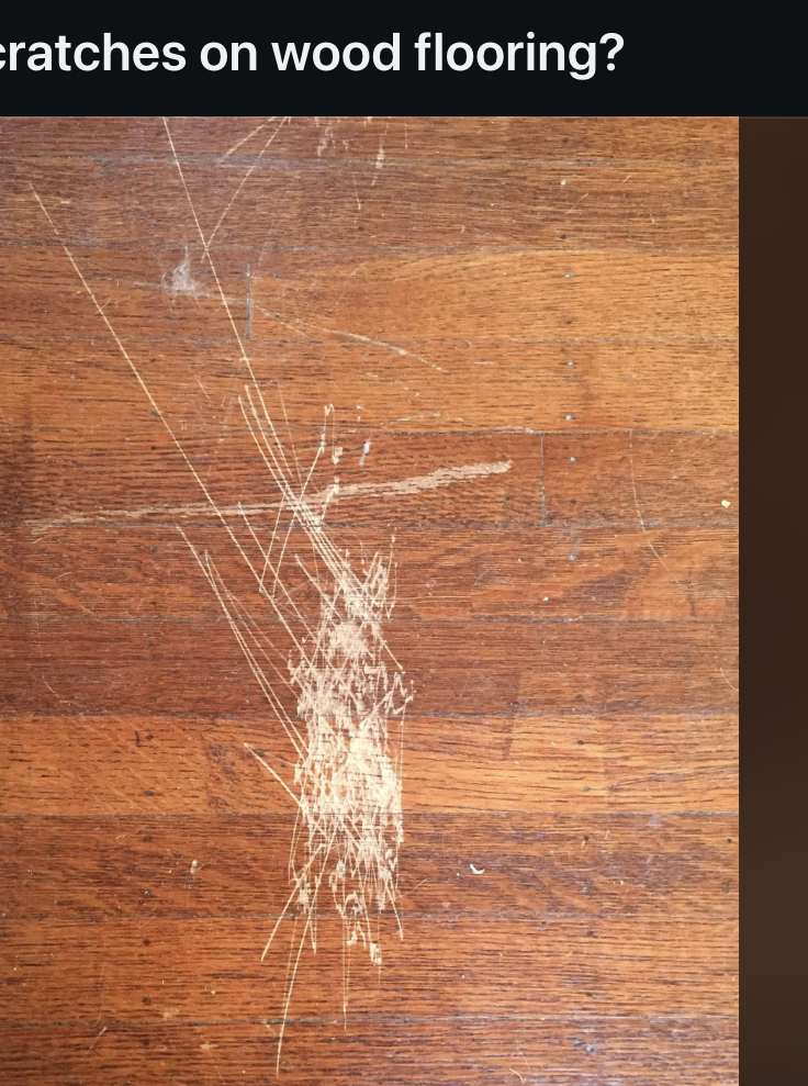 Reddit screenshot of a post by "throwra_t" asking for advice to fix scratches on wood flooring, shown with a photo of scratched wood