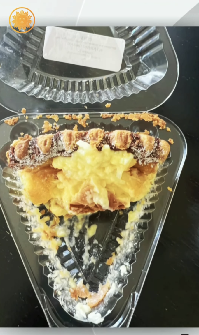 Half-eaten slice of pie in a clear plastic container