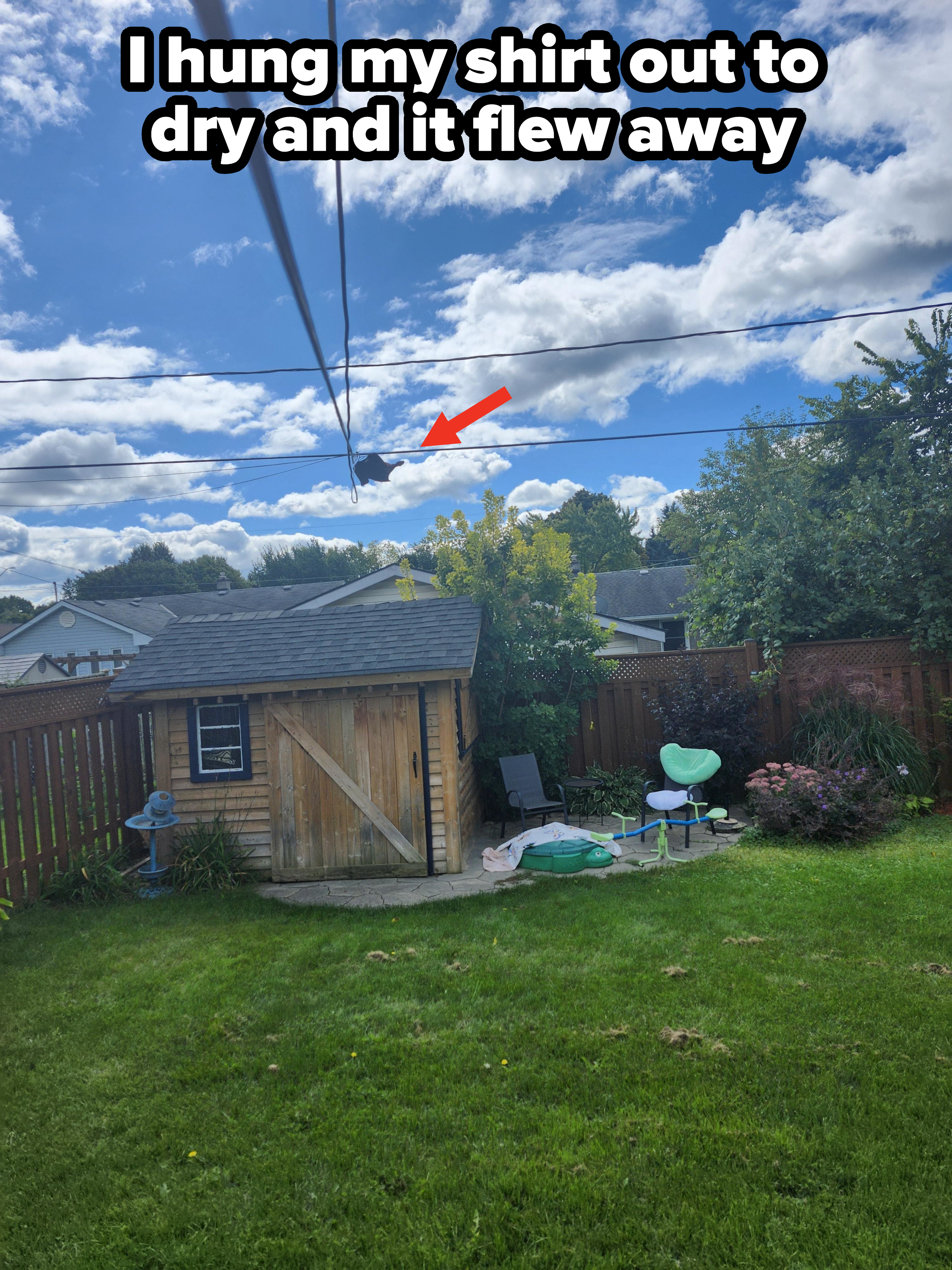 A backyard scene with a wooden shed, kids' swimming pool, slide, and various outdoor items. The sky is cloudy. No people are present