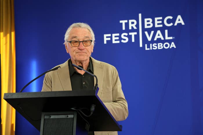 Robert De Niro speaking at a podium at the Tribeca Festival Lisboa event