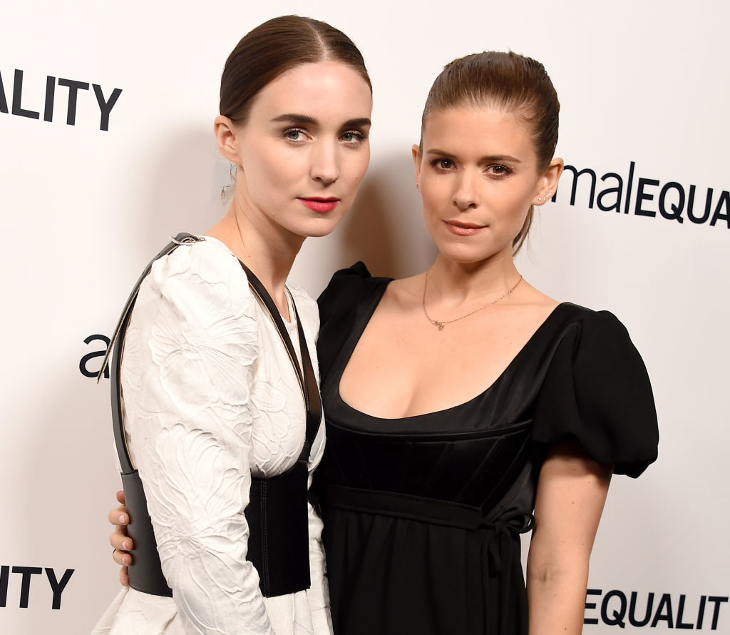 Rooney Mara and Kate Mara pose together at an event, both wearing elegant black and white dresses