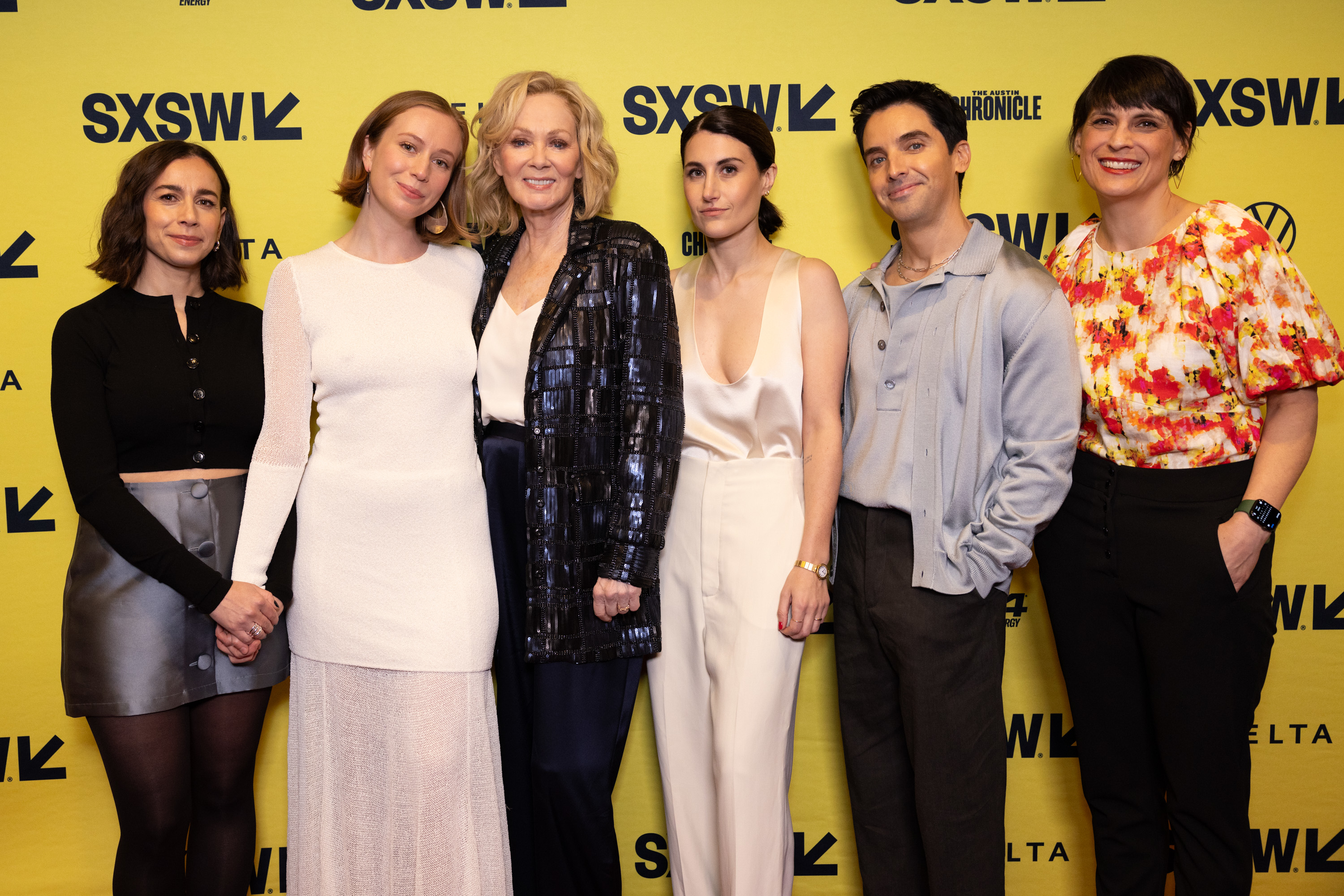 A group posing at a SXSW event in stylish attire