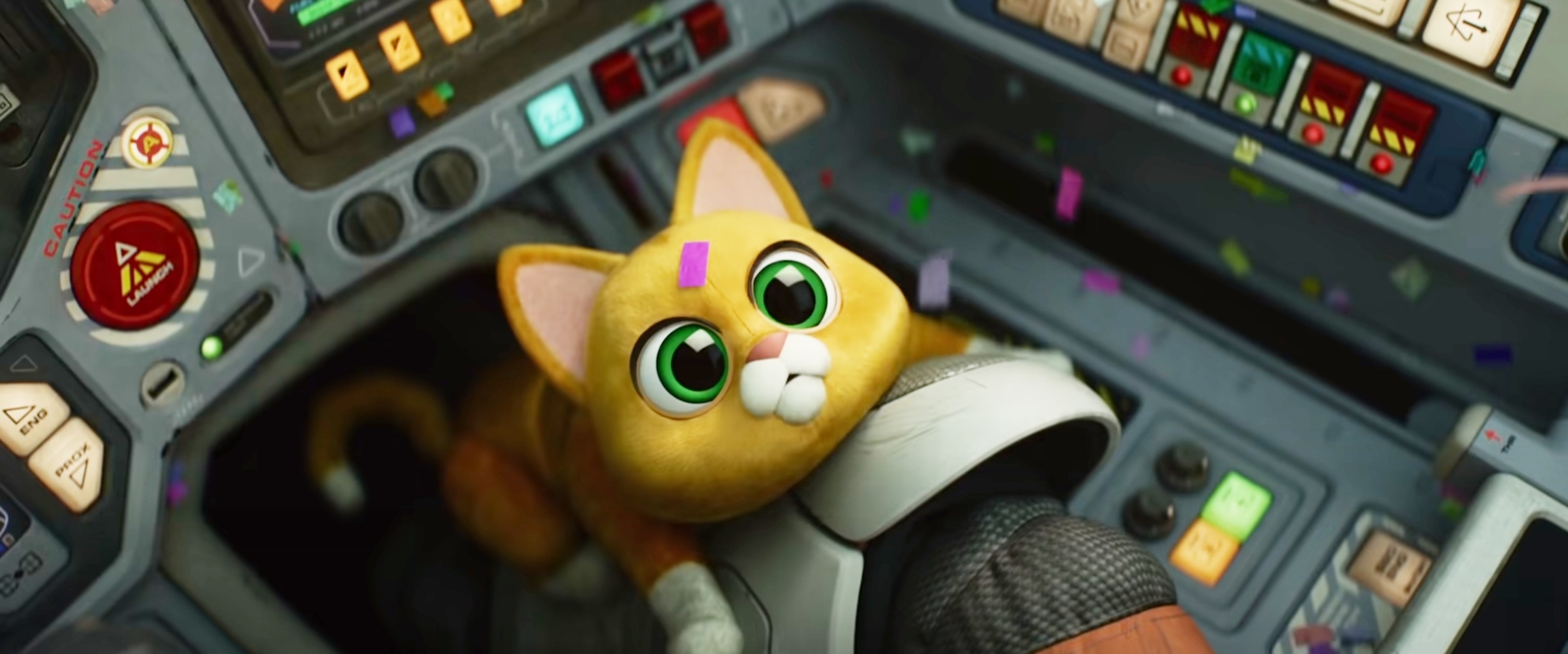 A cute animated cat with large green eyes and a small space helmet on a spaceship control panel surrounded by colorful confetti