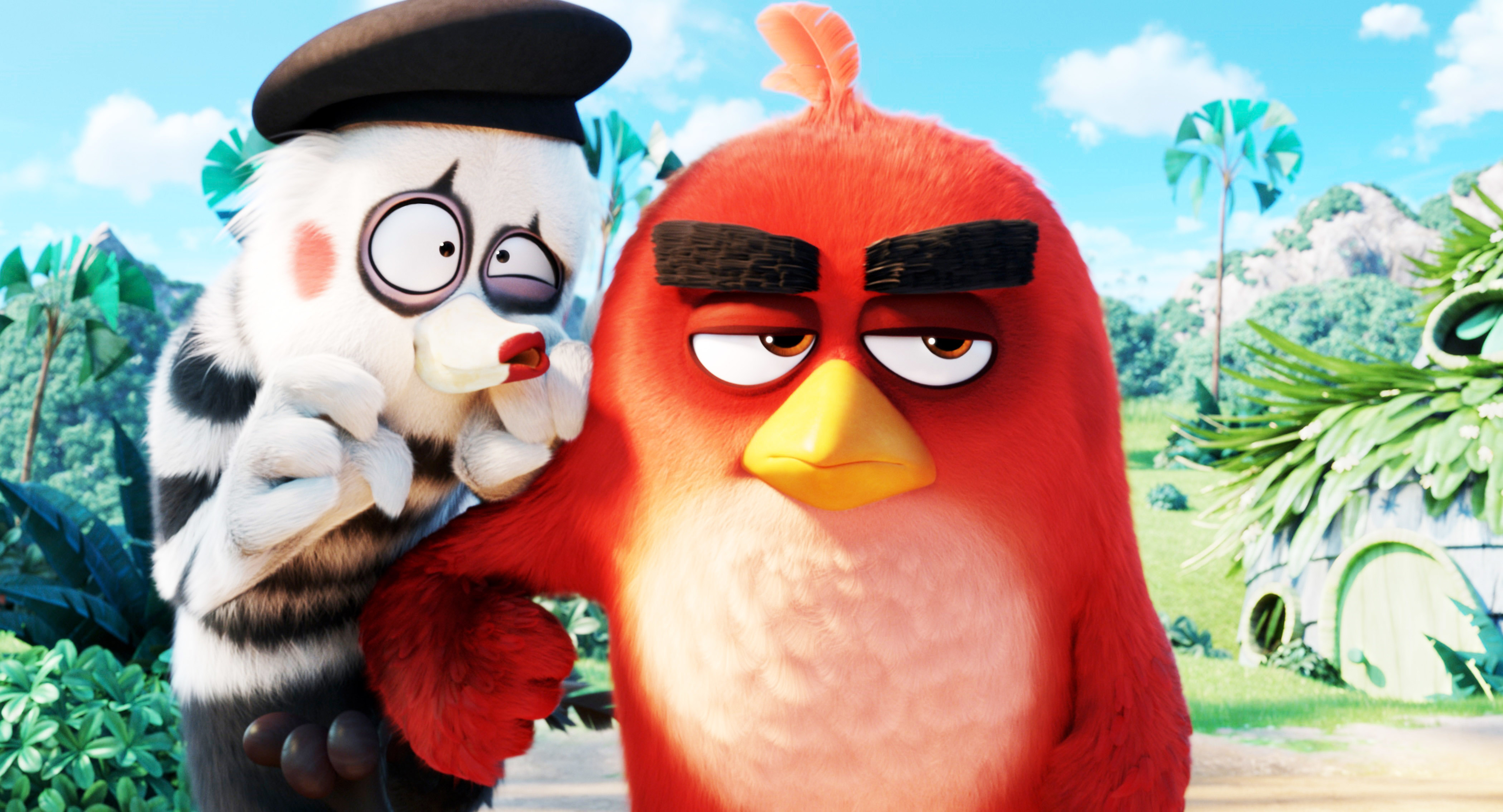 Animated characters Red, a red bird, and Mime, a white mime-like bird with black stripes, posed against a tropical background from The Angry Birds Movie