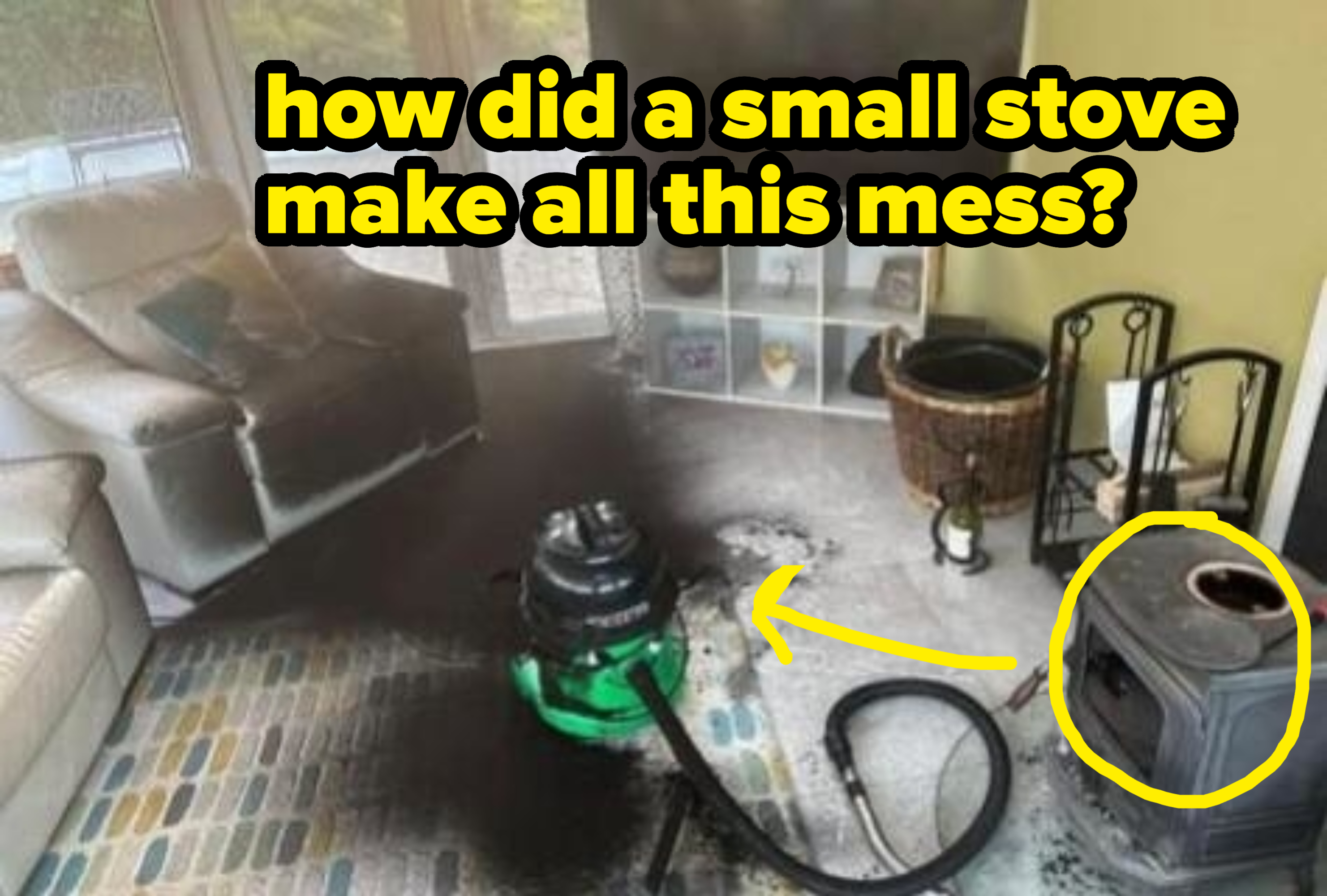 Living room with noticeable smoke damage, soot-covered floor, and a vacuum cleaner attempting cleanup