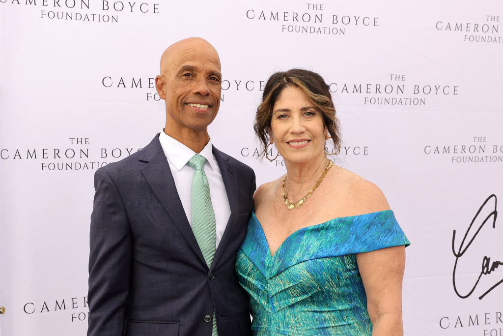 Victor Boyce and Libby Boyce pose for a photo at The Cameron Boyce Foundation event. Victor is in a suit, while Libby wears an off-the-shoulder dress