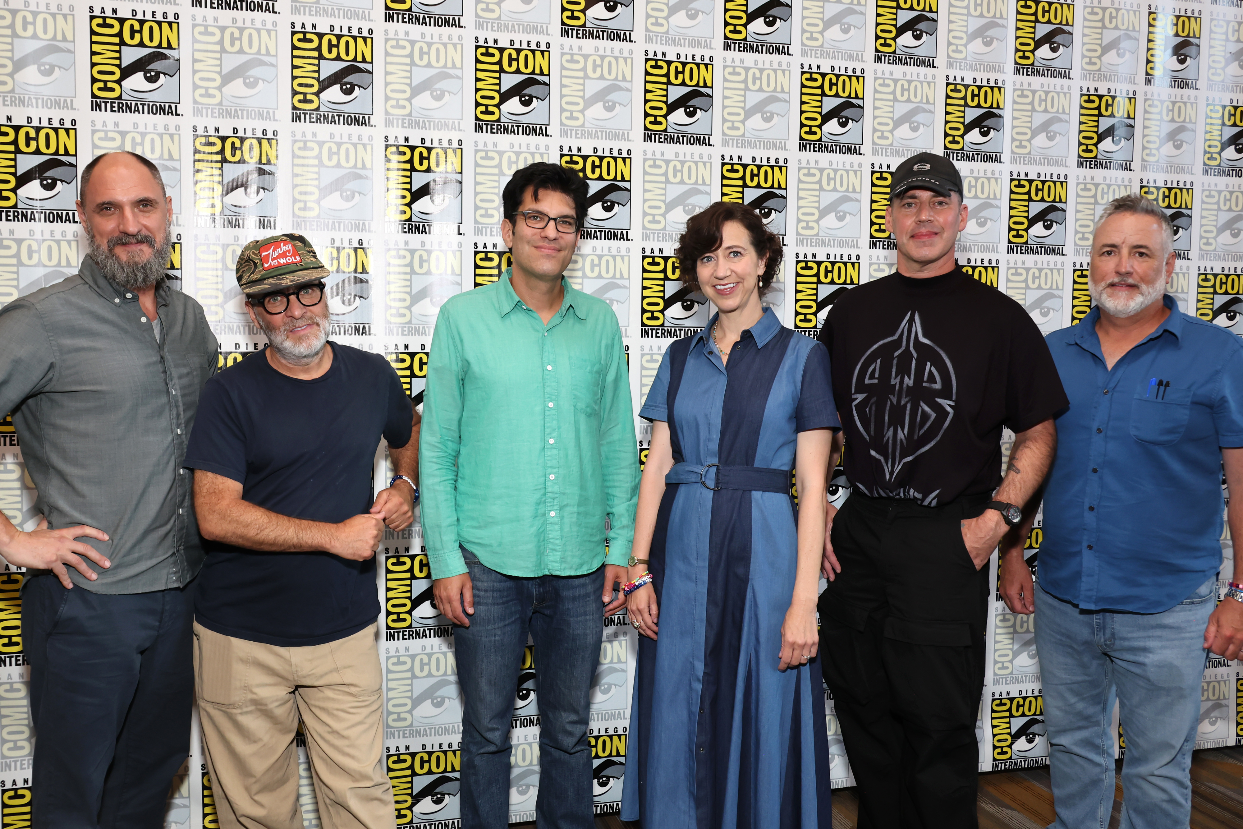Group of six people, including the creators and voice actors of Bob’s Burgers, posing in front of a Comic-Con backdrop