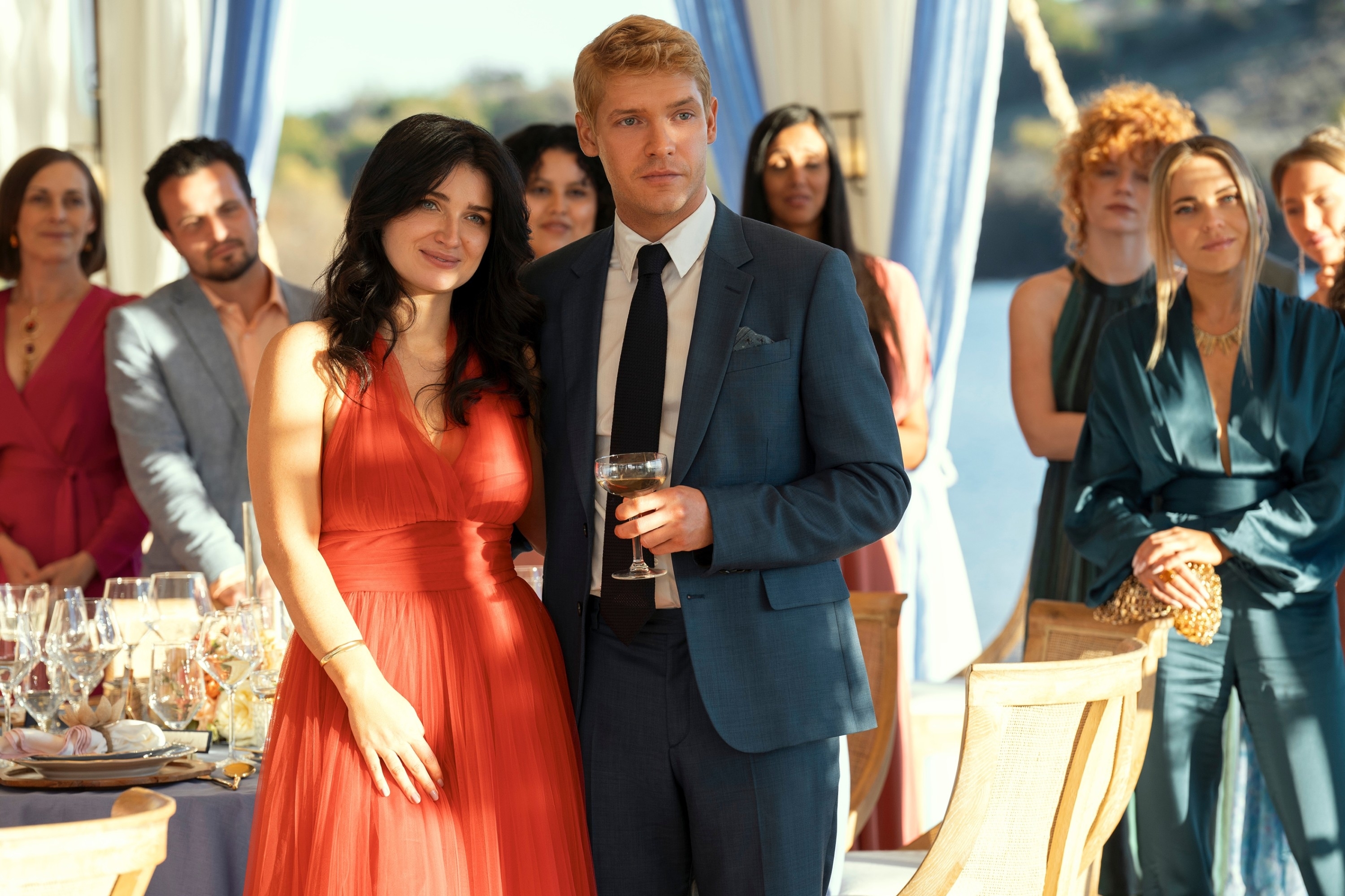 Eve Hewson and Billy Howle standing in a crowd in "The Perfect Couple"
