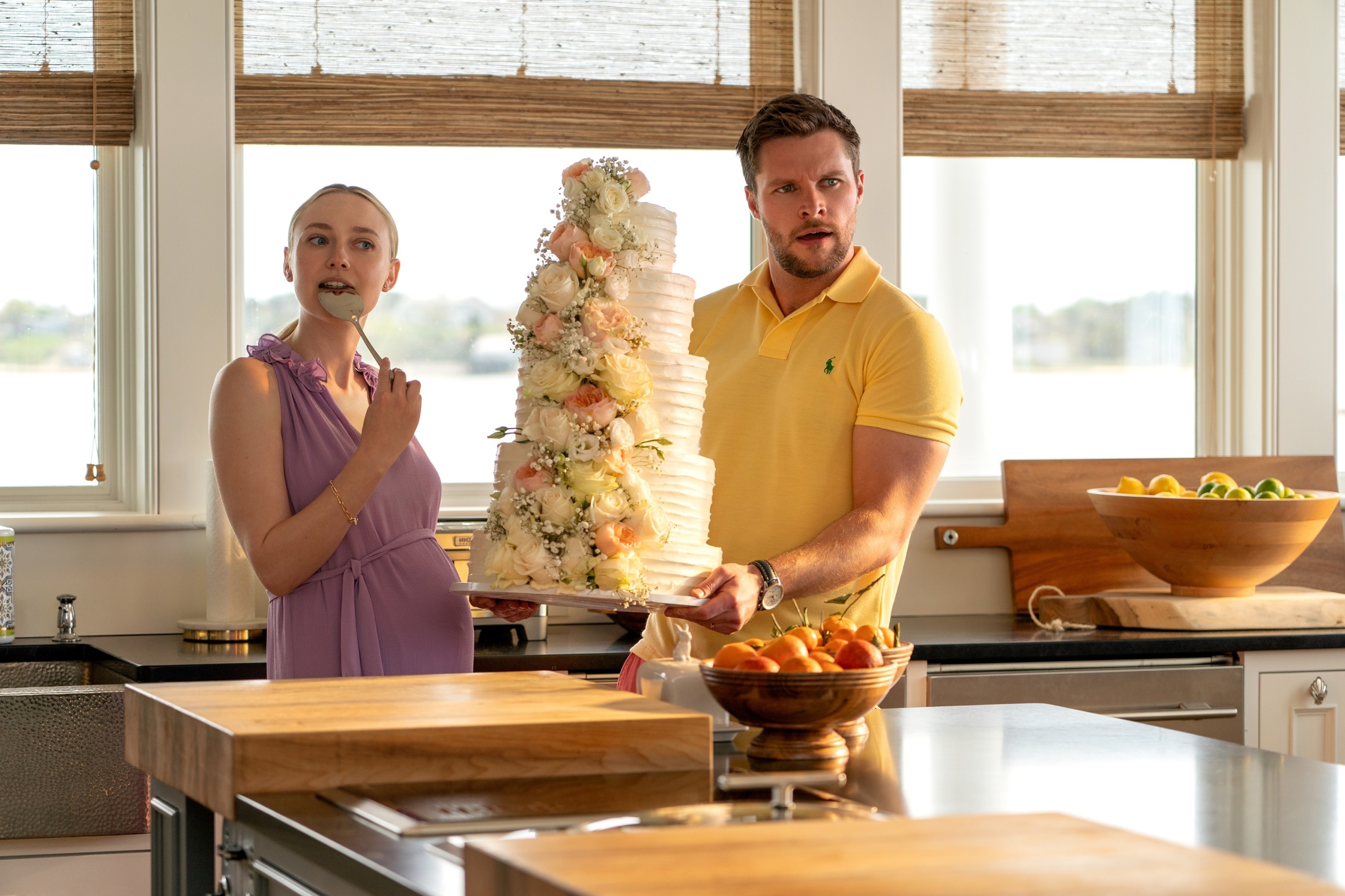 Dakota Fanning and Jack Reynor holding a wedding cake in "The Perfect Couple"
