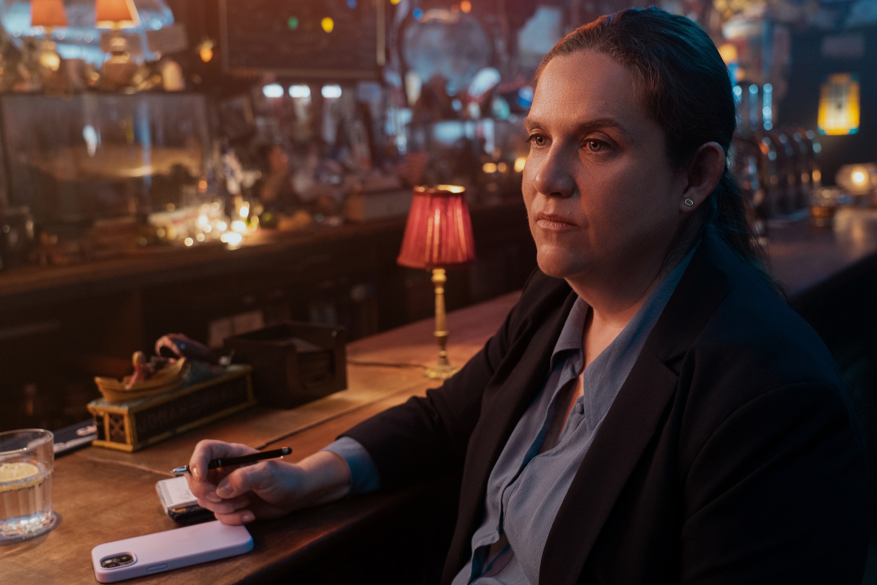 Donna Lynne Champlin sitting at a bar in "The Perfect Couple"
