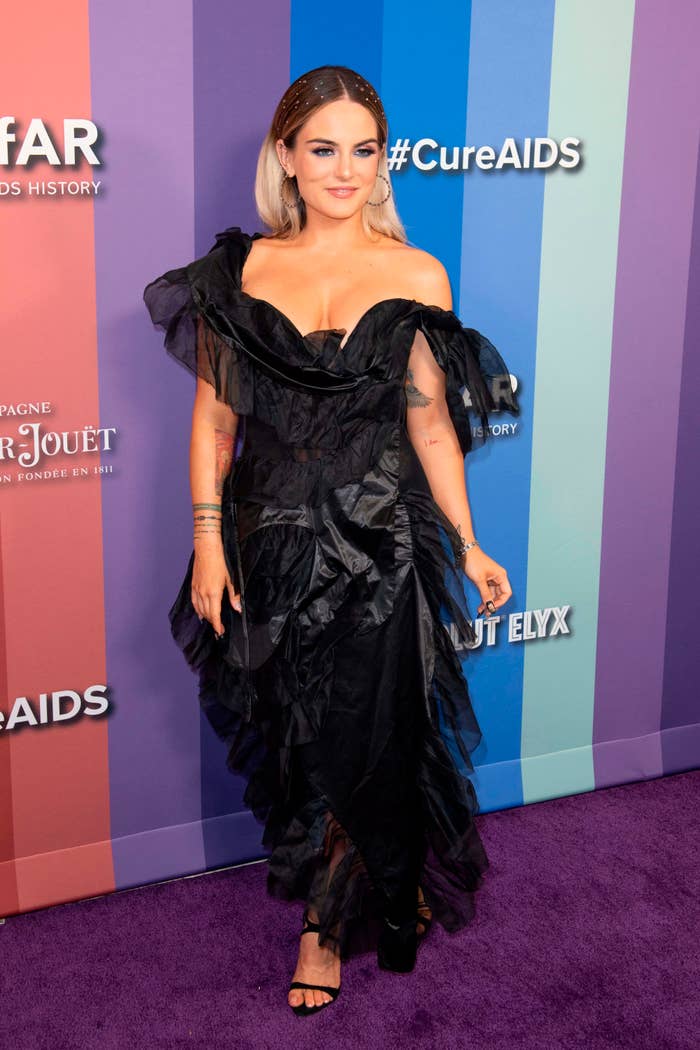 JoJo at amfAR Gala wearing a stylish off-shoulder ruffled dress with a high slit