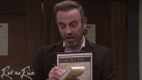 A man holding a menu and speaking animatedly.