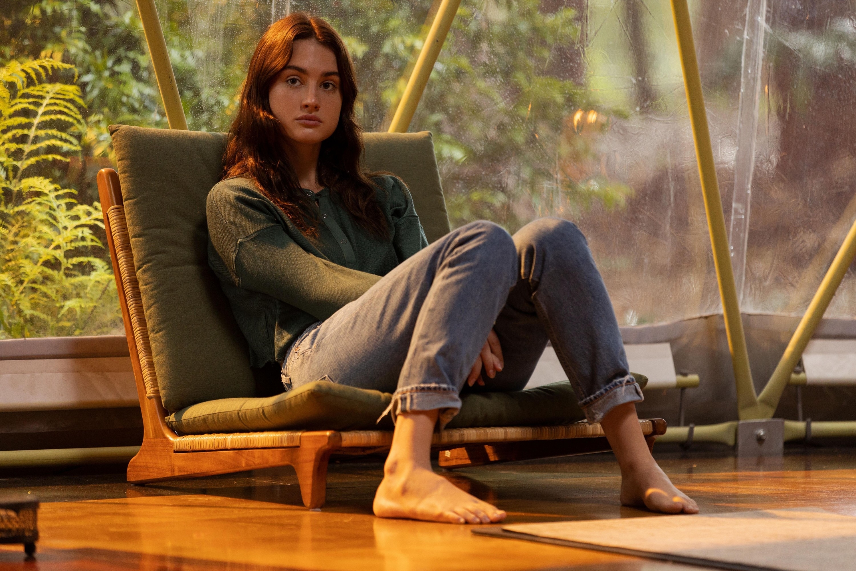 Grace Van Patten sitting on a chair in "Nine Perfect Strangers"