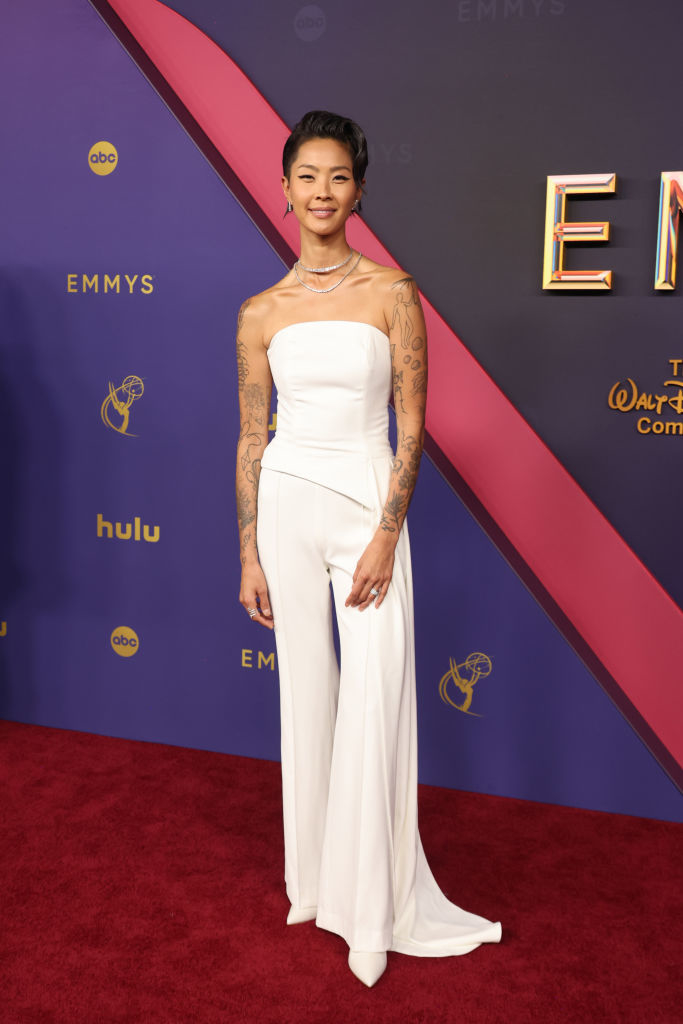 Person in a white strapless jumpsuit on the red carpet at the Emmys