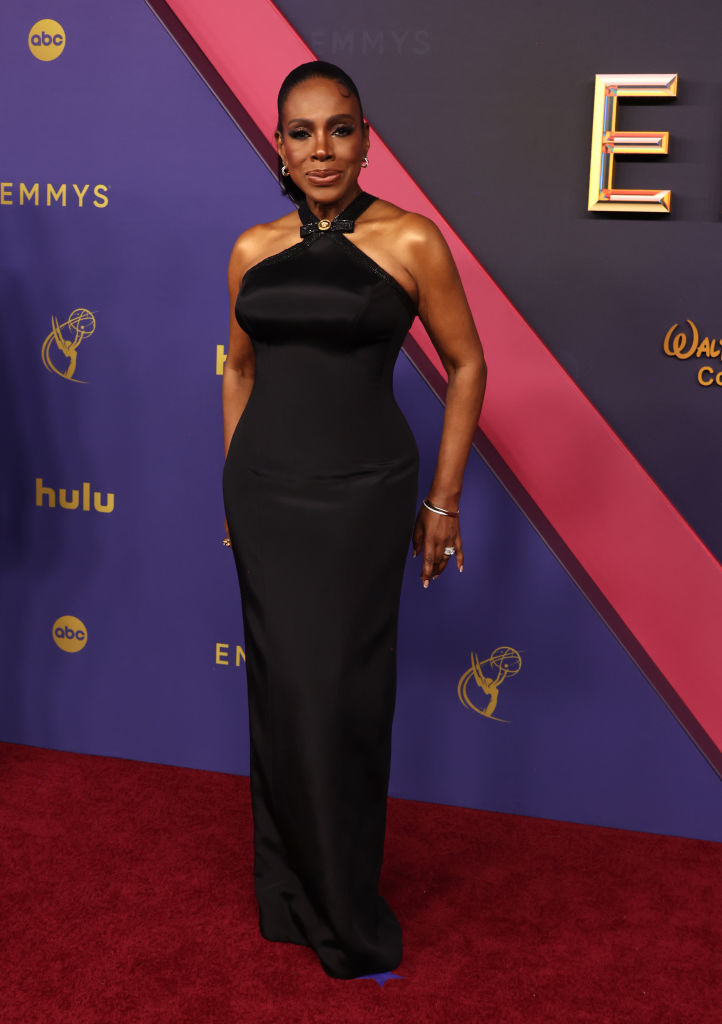 Sheryl Lee Ralph posing on the red carpet at the Emmys, wearing a stylish, sophisticated halter gown
