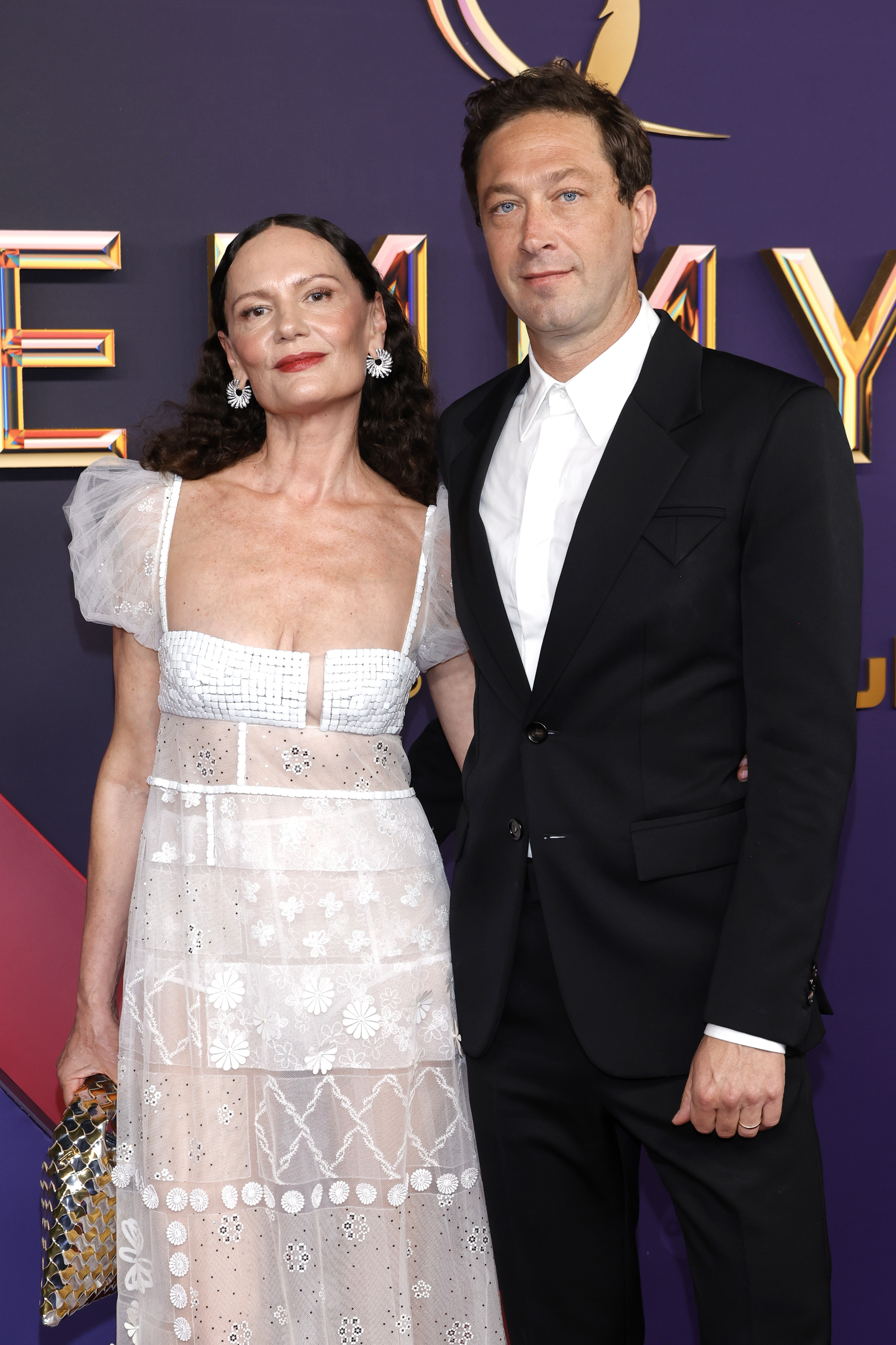 Emmy Awards red carpet: Yelena Yemchuk in a sheer white gown with puff sleeves and Ebon Moss-Bachrach in a classic black tuxedo