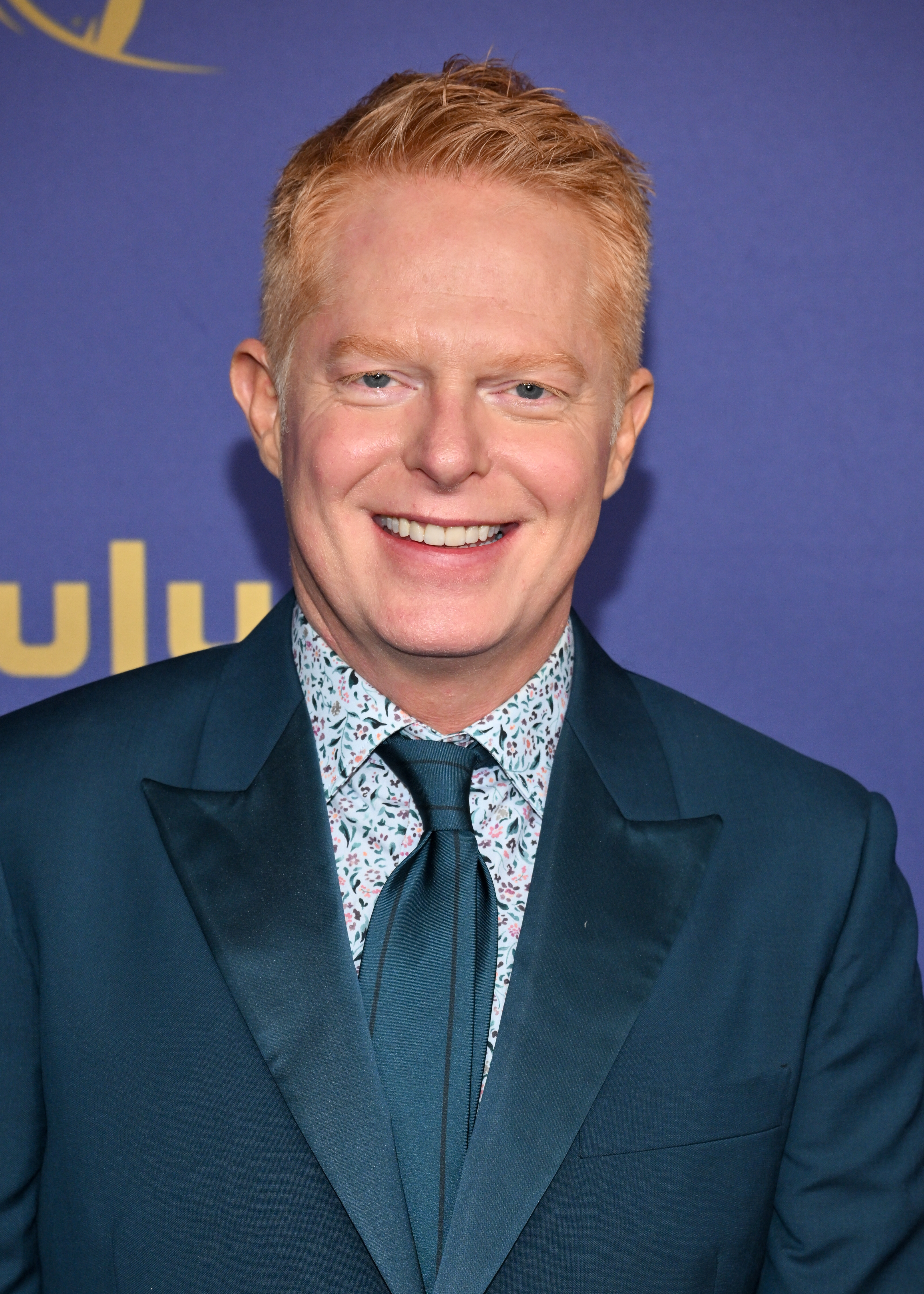 Jesse Tyler Ferguson smiling on a red carpet