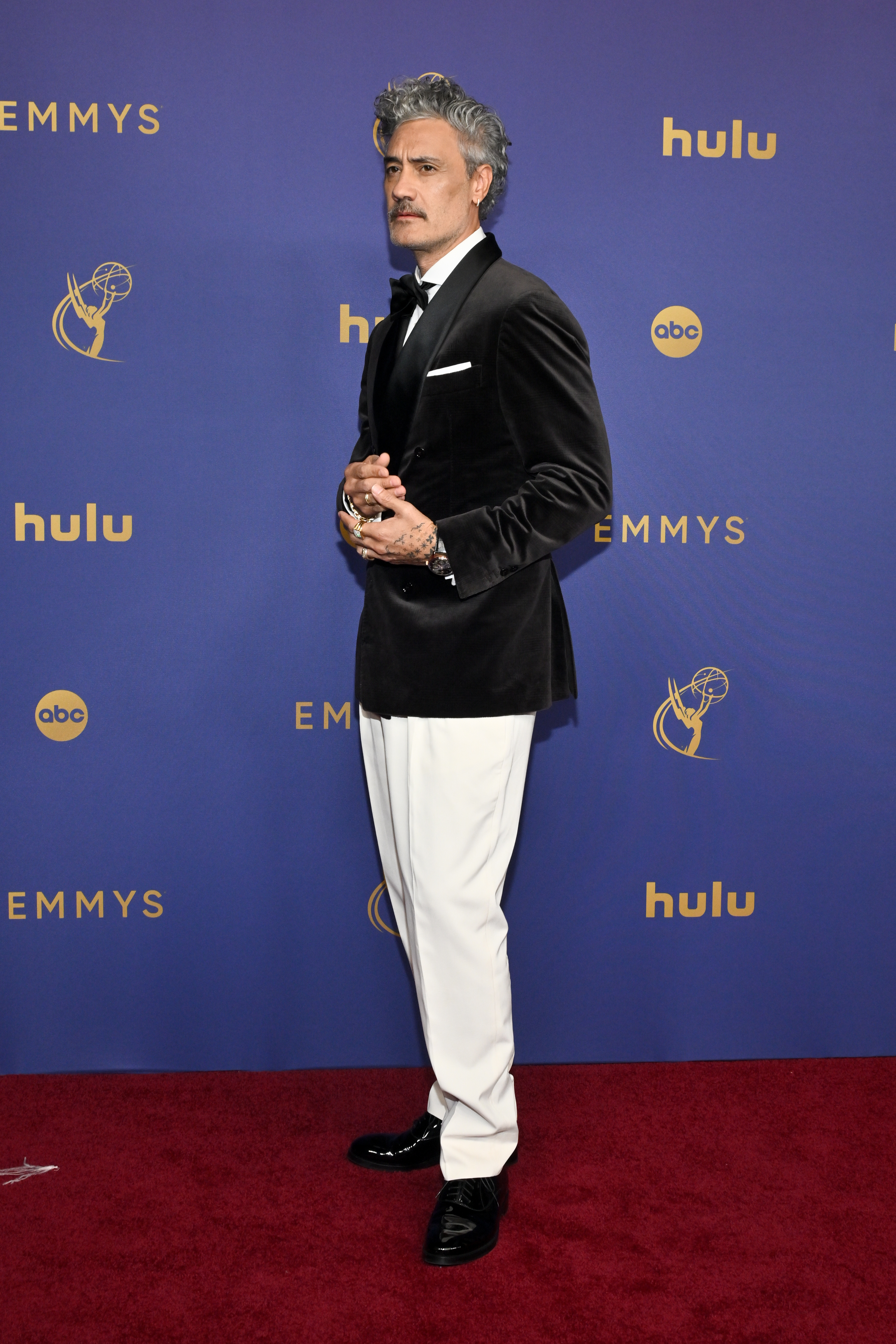 Taika Waititi poses on the red carpet at the Emmys