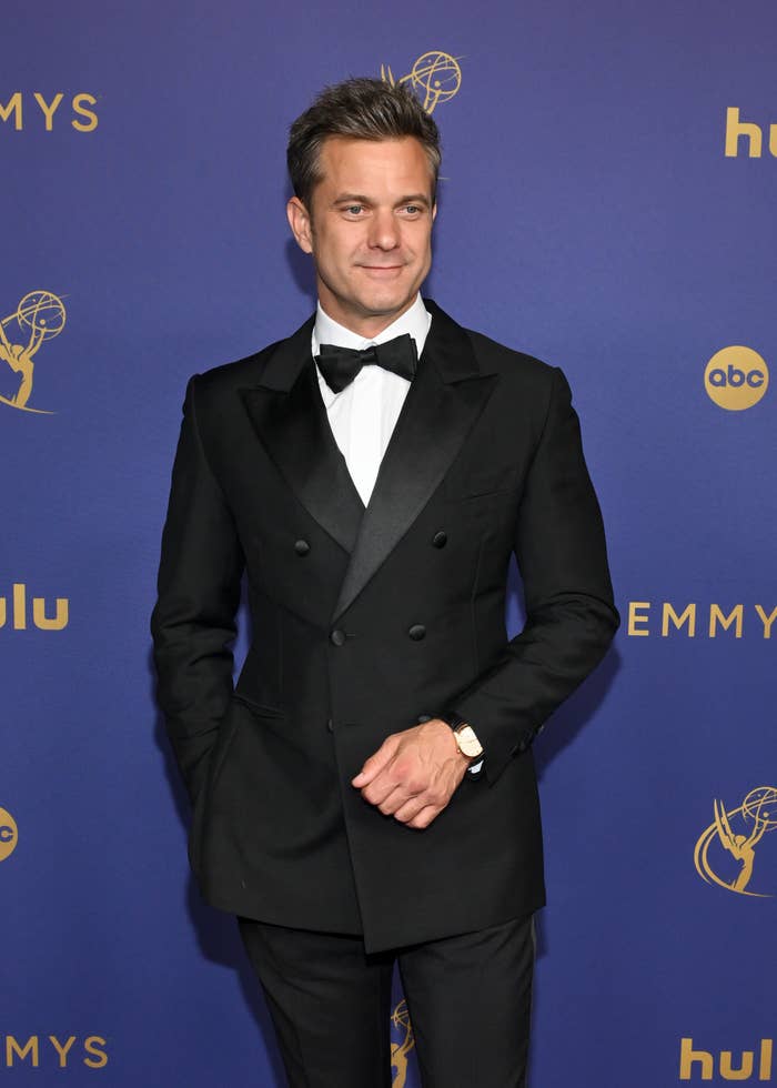 Joshua Jackson poses on the Emmys red carpet in a tuxedo