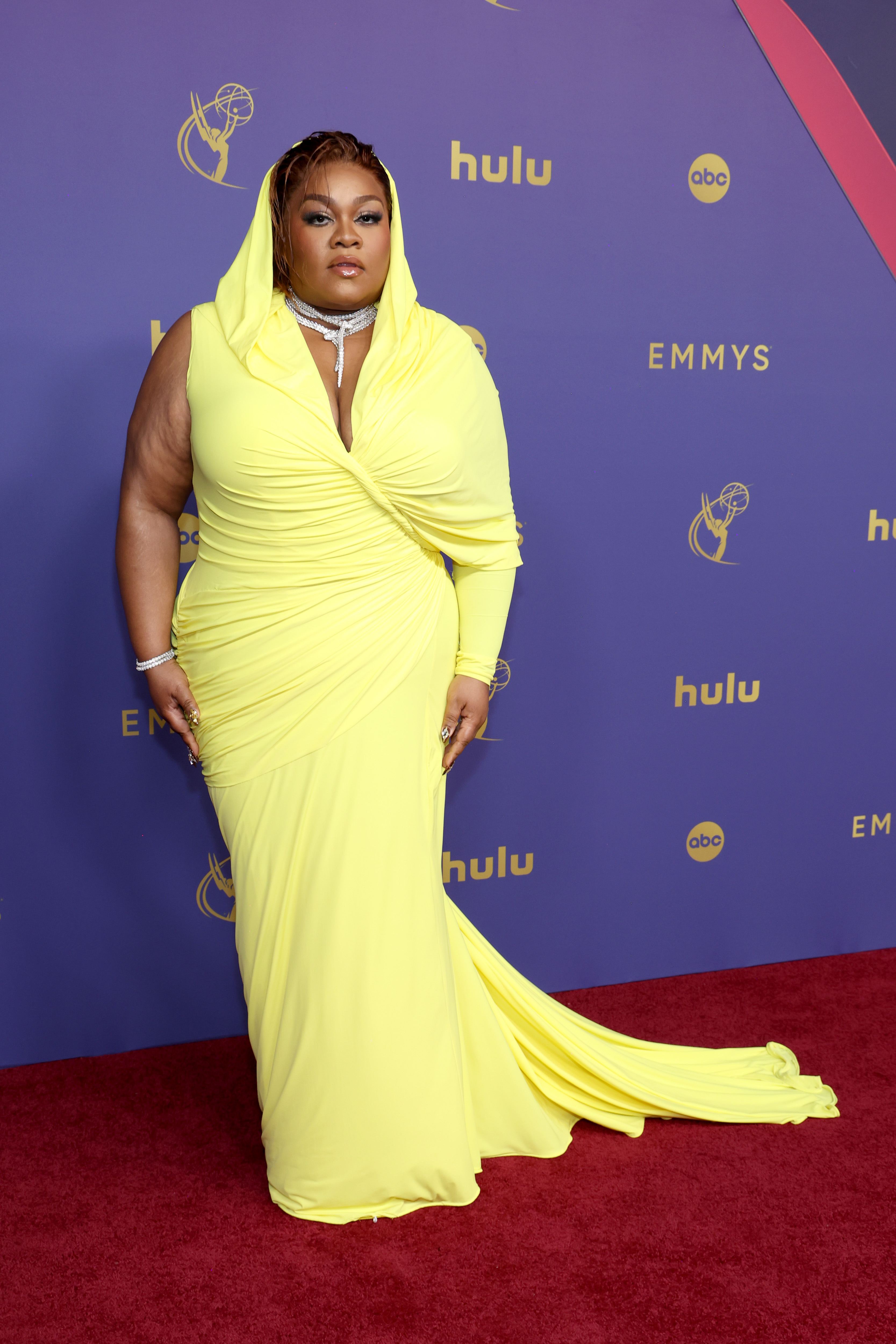 Da'Vine Joy Randolph on the red carpet in a draped, floor-length gown with a hood at the Emmys
