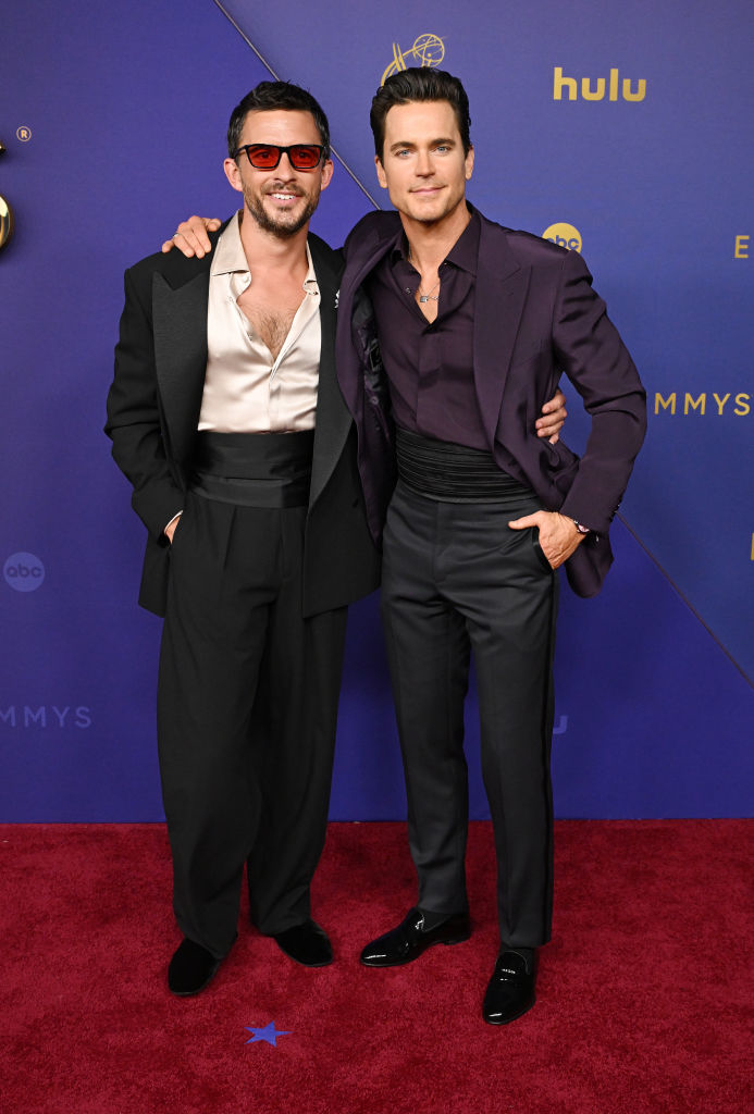 Jonathan Bailey and Matt Bomer on the red carpet at an event, dressed in stylish, formal evening wear