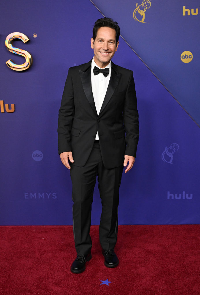 Paul Rudd in a black tuxedo with a bow tie on the red carpet at an Emmy Awards event