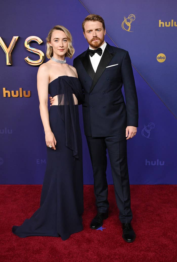 Saoirse Ronan in a strapless gown and Jack Lowden in a suit pose together on the red carpet at the Emmy Awards