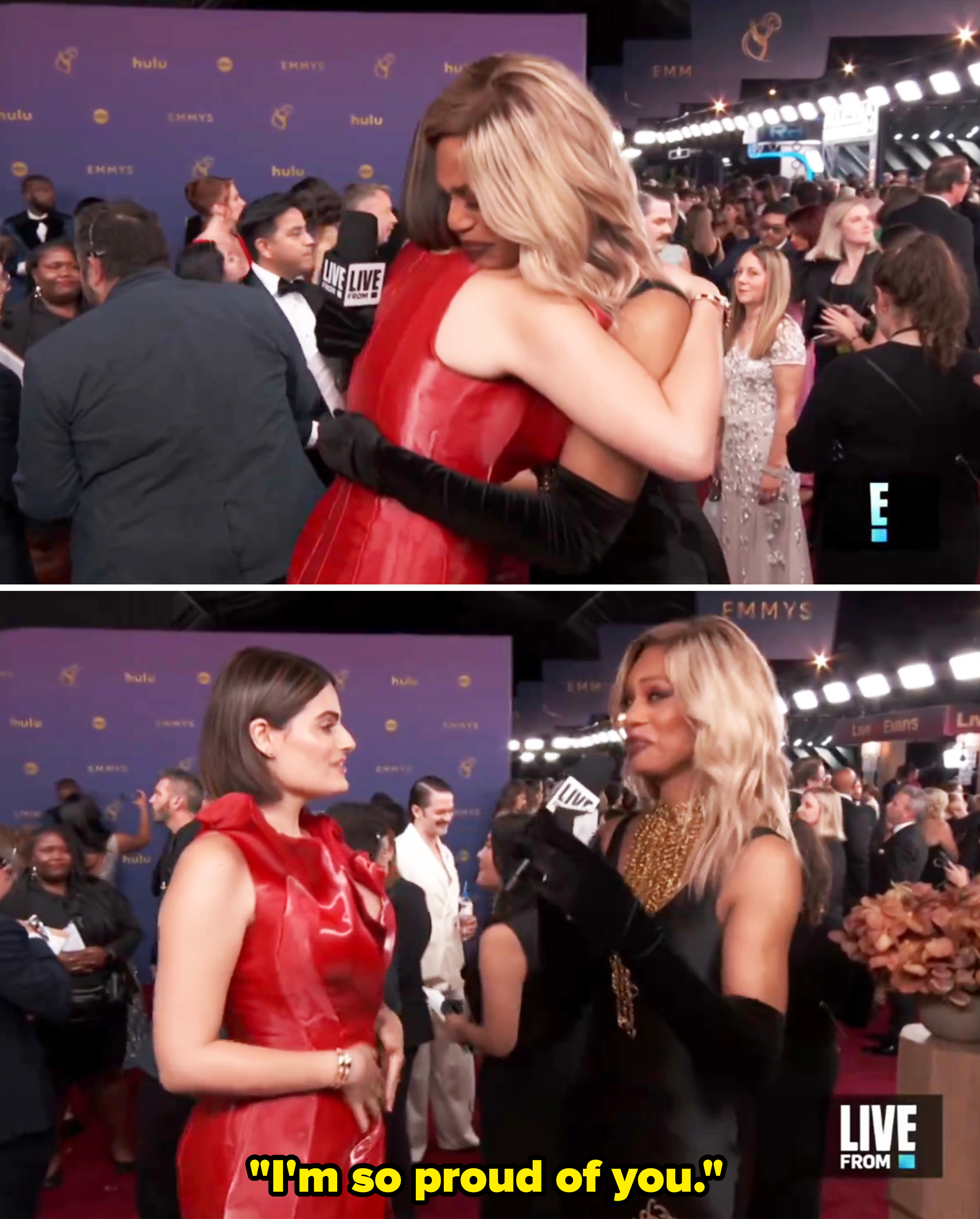 Nava Mau and Laverne Cox talk and hug on the red carpet at the Emmys, with Laverne in a black dress and gloves, and Nava in a red dress